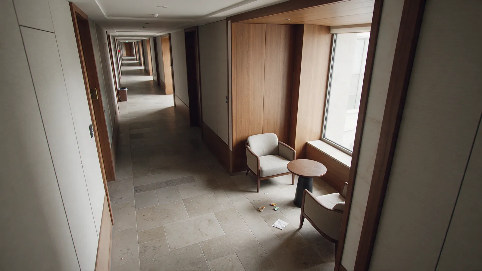 Illustrative hotel public corridor with litter on the floor.