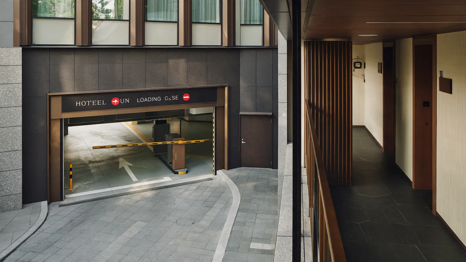 Illustrative hotel loading-area gate left partly open.