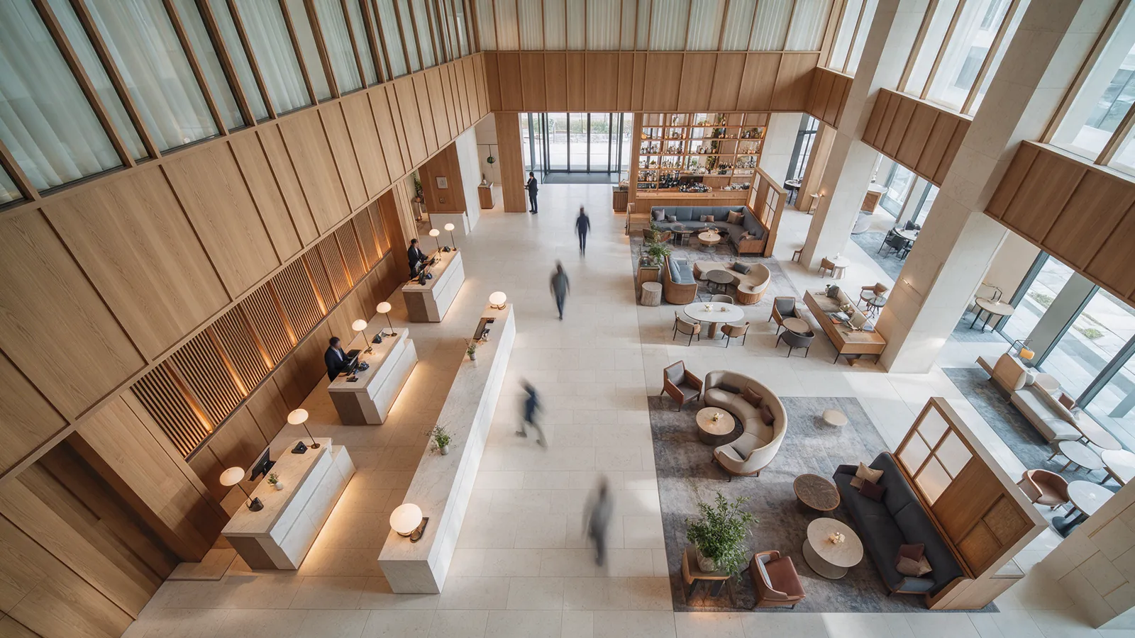 Illustrative distant hotel guests moving through a lobby with no visible faces.