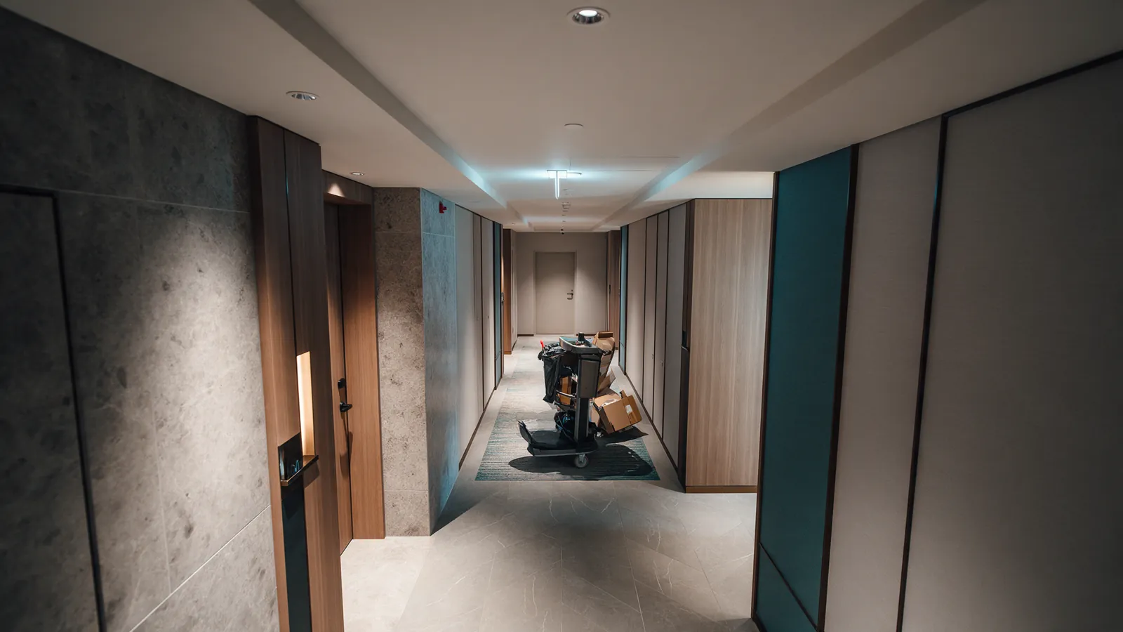 Illustrative service trolley blocking the approach to a hotel exit door.