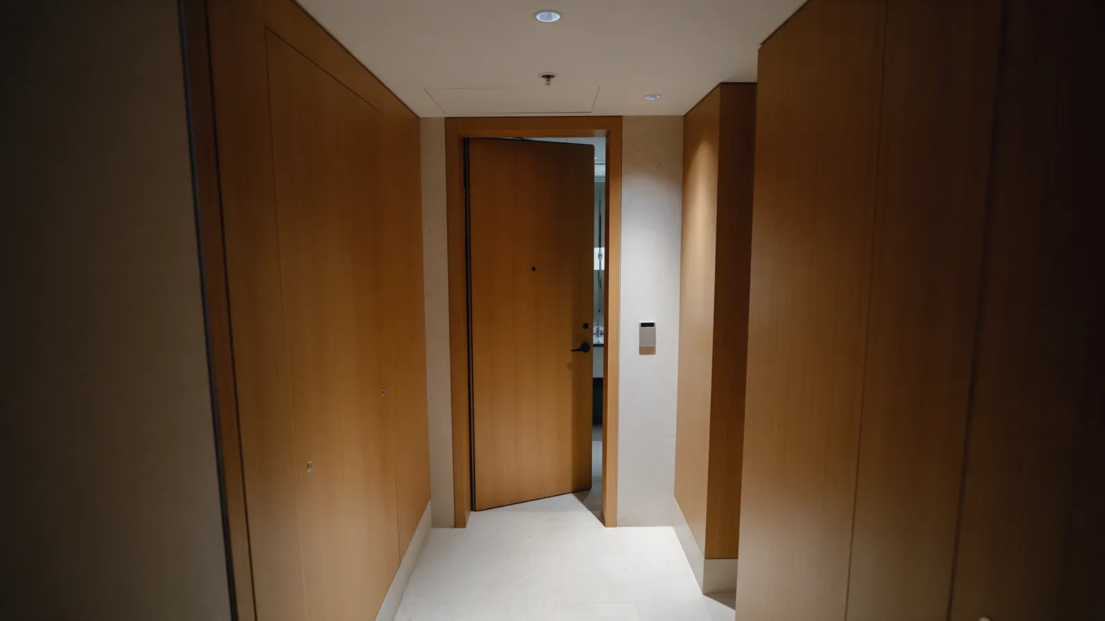 Illustrative hotel service corridor with a staff access door left ajar.